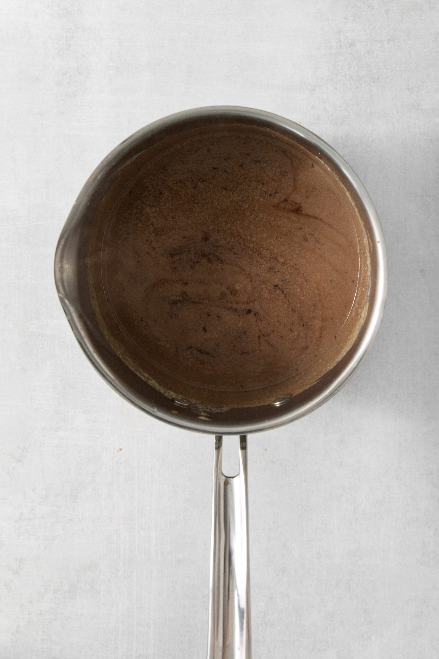 custard mixture with chocolate mixed in, in a pan