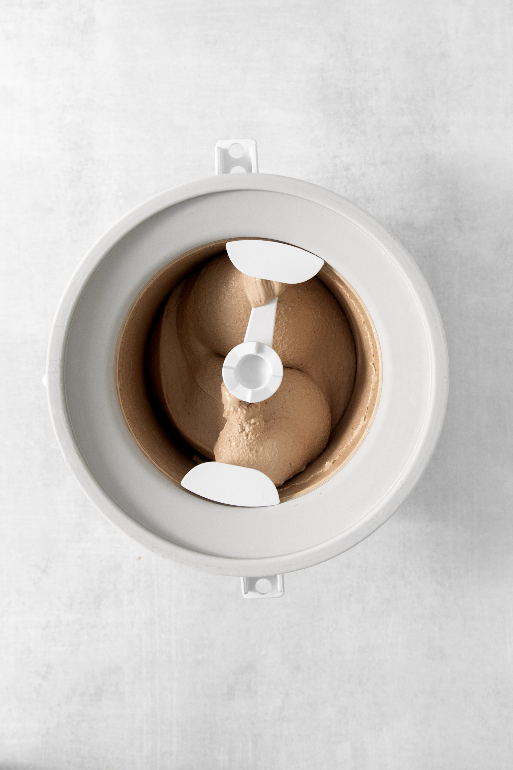 hot chocolate ice cream mixture in an ice cream maker bowl
