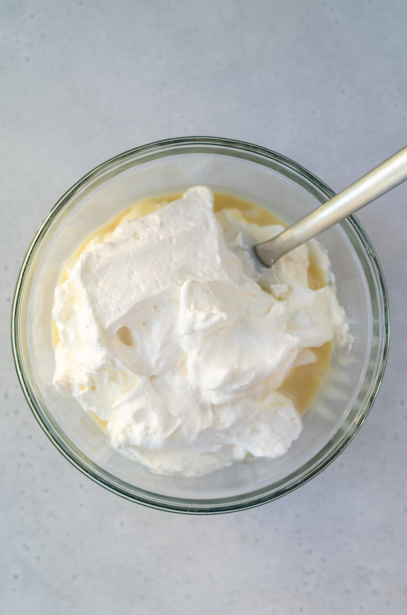 sweetened condensed milk and whipped cream in a bowl