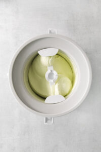 lime ice cream in a ice cream machine mixing bowl