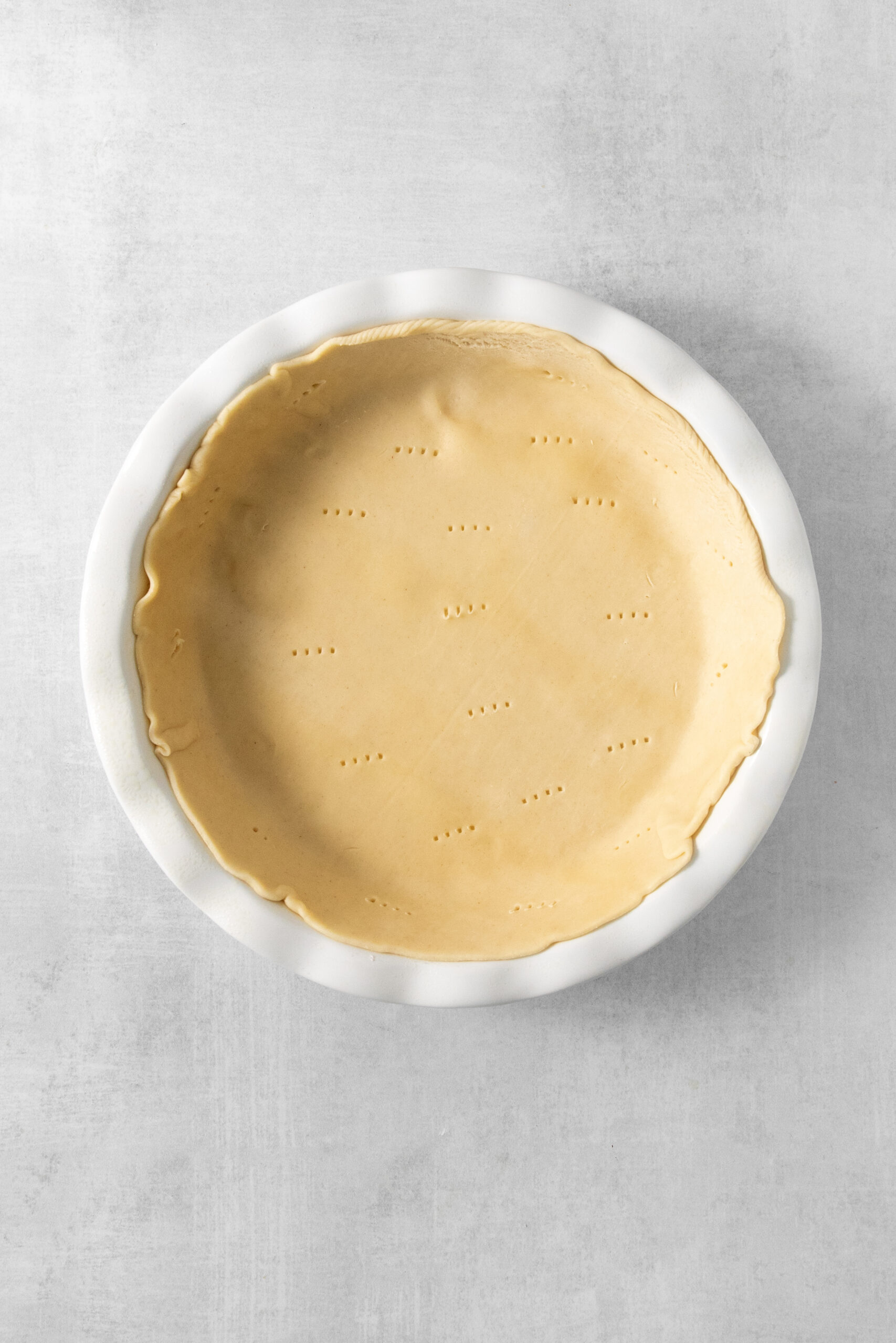 raw pie dough in a pie pan