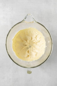 butter and sugar creamed in a clear mixing bowl